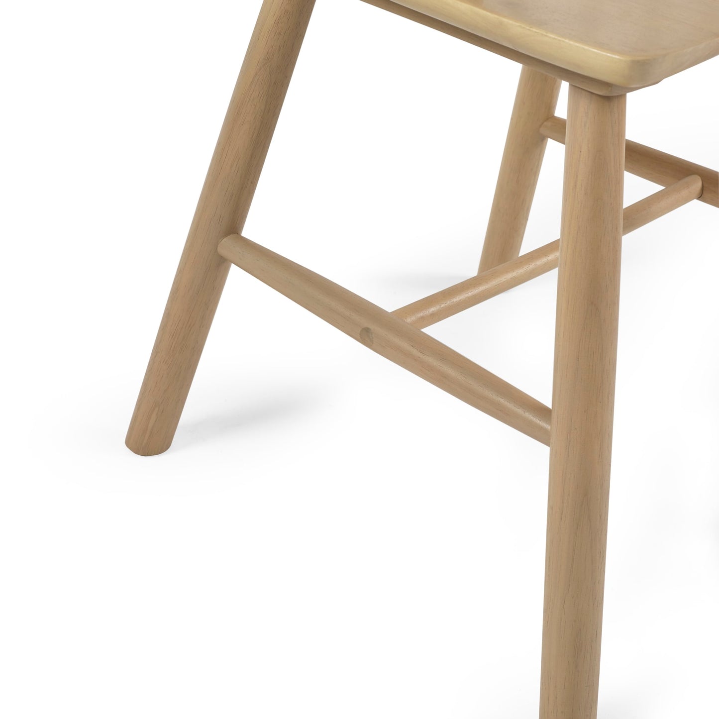 Close-up view of the splayed wooden legs and H-bar stretcher support on the Kaito oak chair