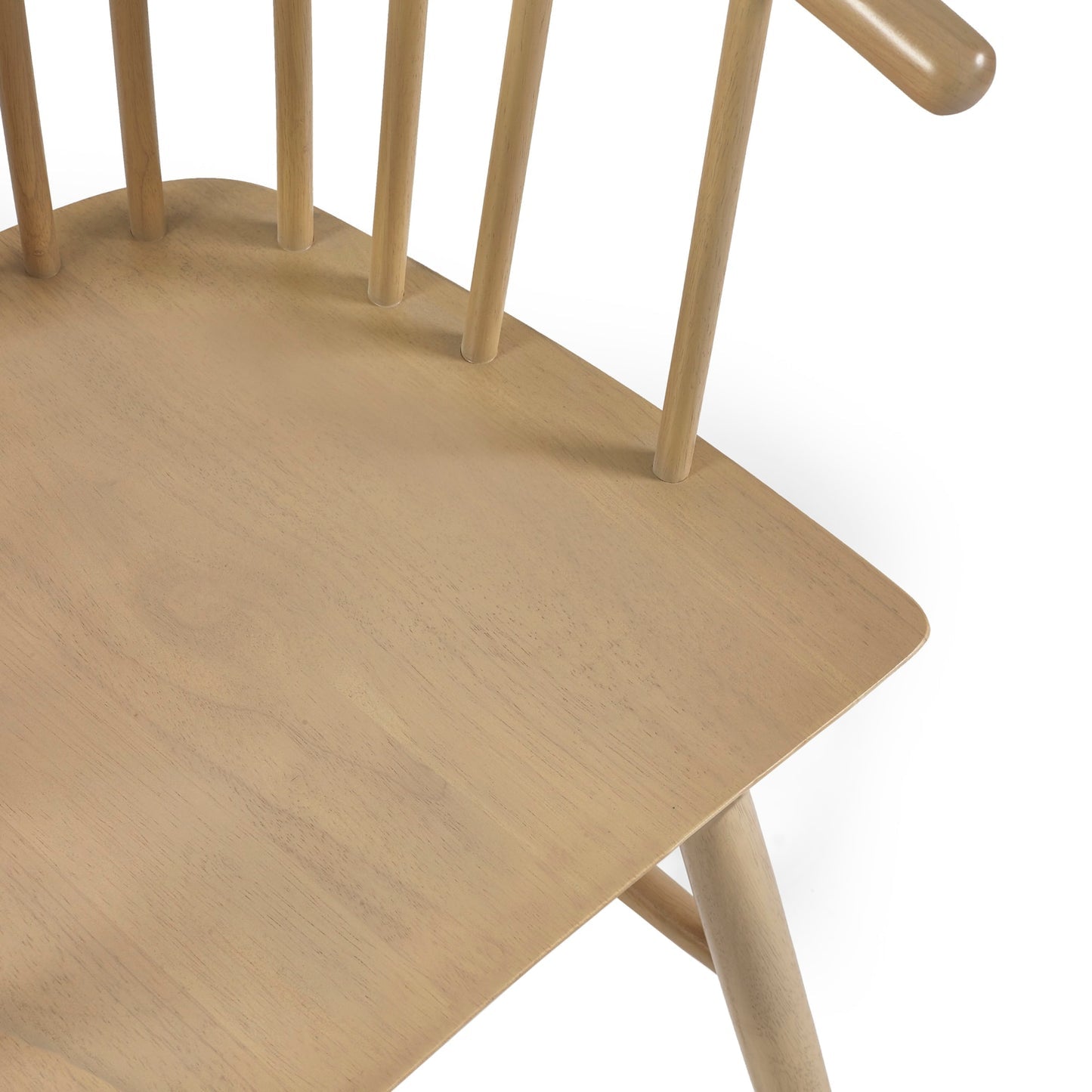 High angle studio view showcasing the smooth wood grain seat pan of the Kaito oak spindle dining chair