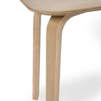 Close-up shot of the seamless bentwood leg joint and natural oak veneer finish on the Kaito dining bench