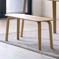 Kaito oak wooden dining bench styled beside a matching dining table on a textured rug in a bright modern home