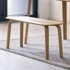 Kaito oak wooden dining bench styled beside a matching dining table on a textured rug in a bright modern home
