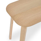 High angle studio view highlighting the smooth rounded seat corners and natural wood grain of the Kaito oak bench
