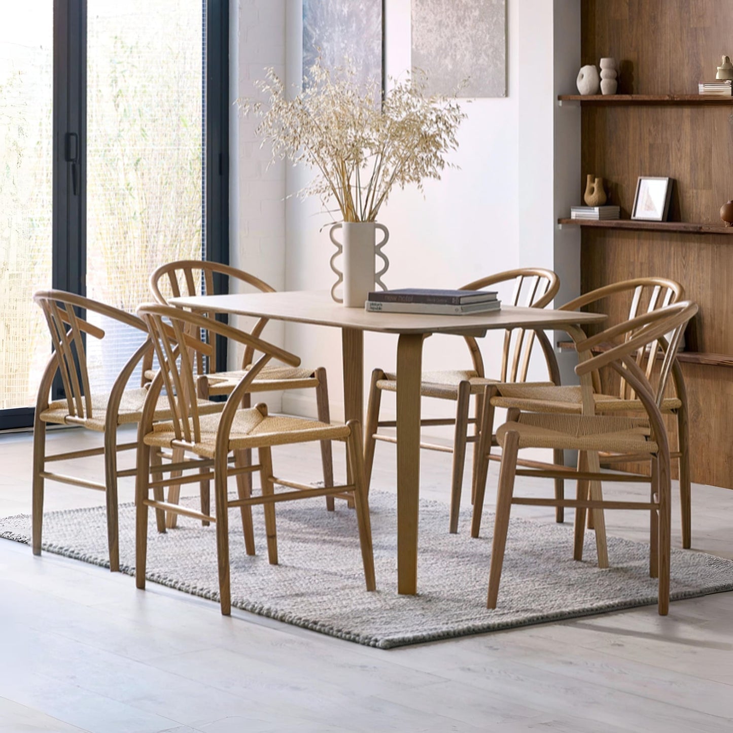 Kaito oak wooden dining table styled with matching spindle chairs in a modern home environment