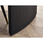 Low angle shot showing the curved fluted pedestal base construction of the Louis black dining table