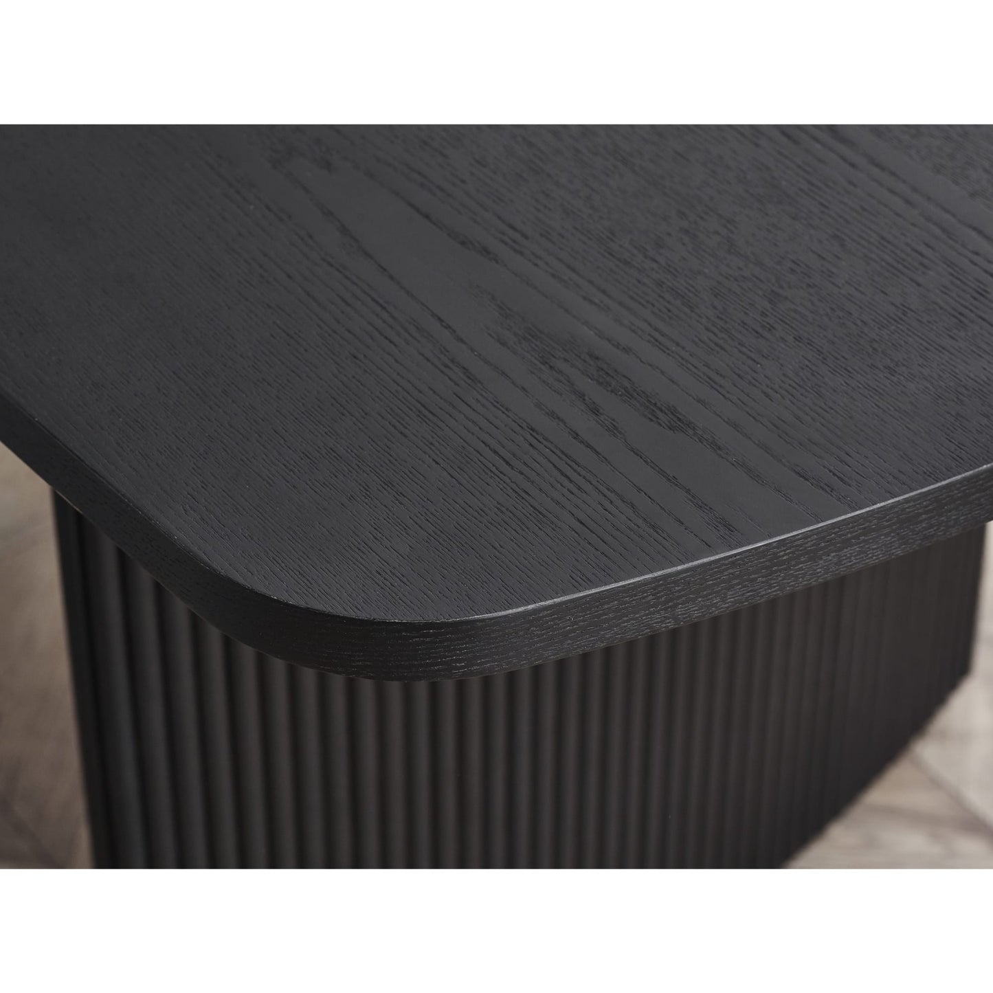 Detail shot highlighting the rounded corner edge profile and black wood grain top on the Louis table