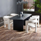 Louis black fluted extending dining table set with grey velvet armchairs and candles in a dark modern dining room