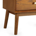 Close-up shot of the brushed gold knob hardware and splayed tapered leg on the Lowry Cherry Ash bedside table