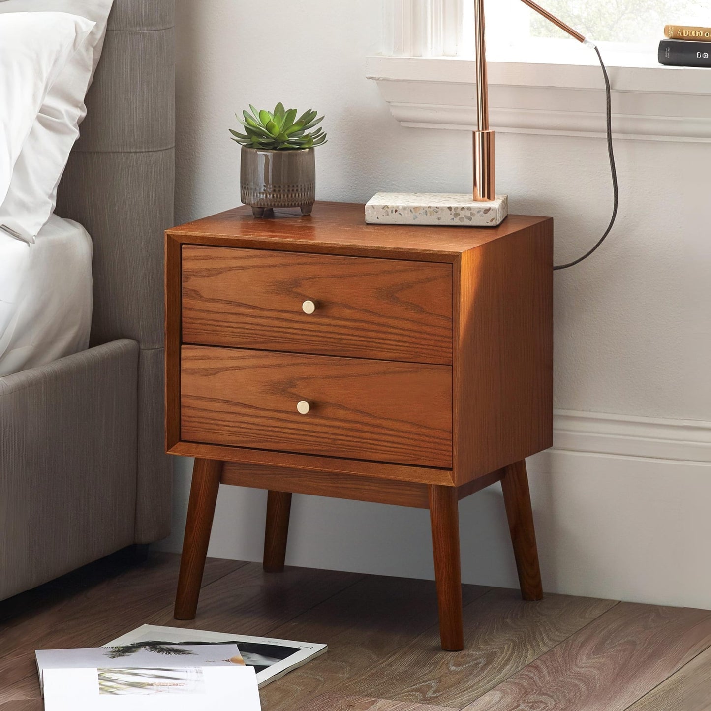 Lowry Cherry Ash 2 drawer bedside table styled next to a bed in a modern bedroom