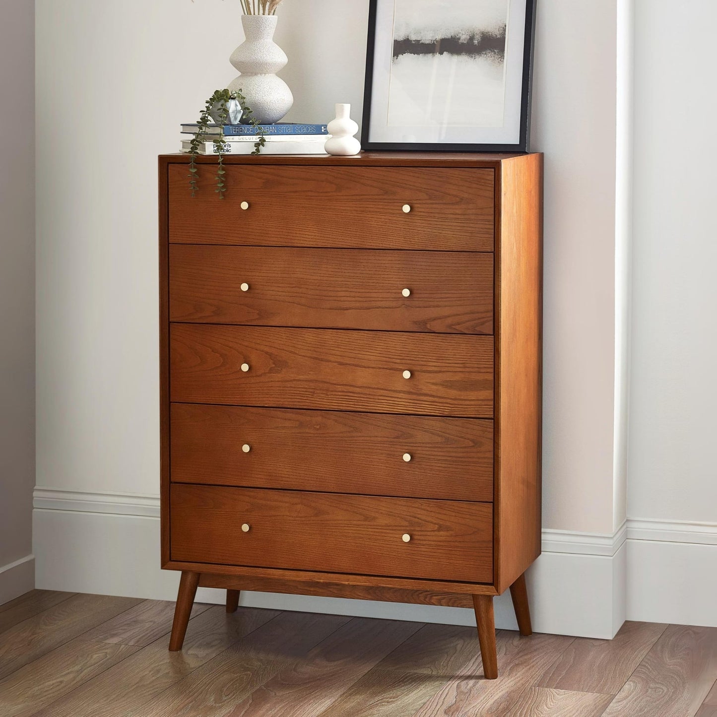 Lowry Cherry Ash 5 drawer tallboy chest styled in a modern bedroom setting