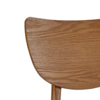 Close-up view of the rounded backrest showcasing the organic grain of the exquisite cherry ash veneer