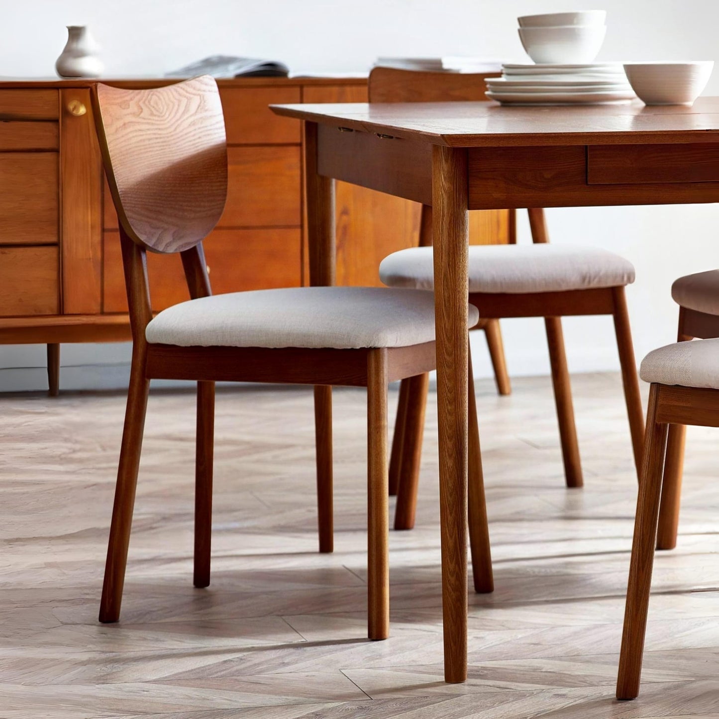 Set of 2 Lowry dining chairs in exquisite cherry ash veneer styled around a dining table in a modern home