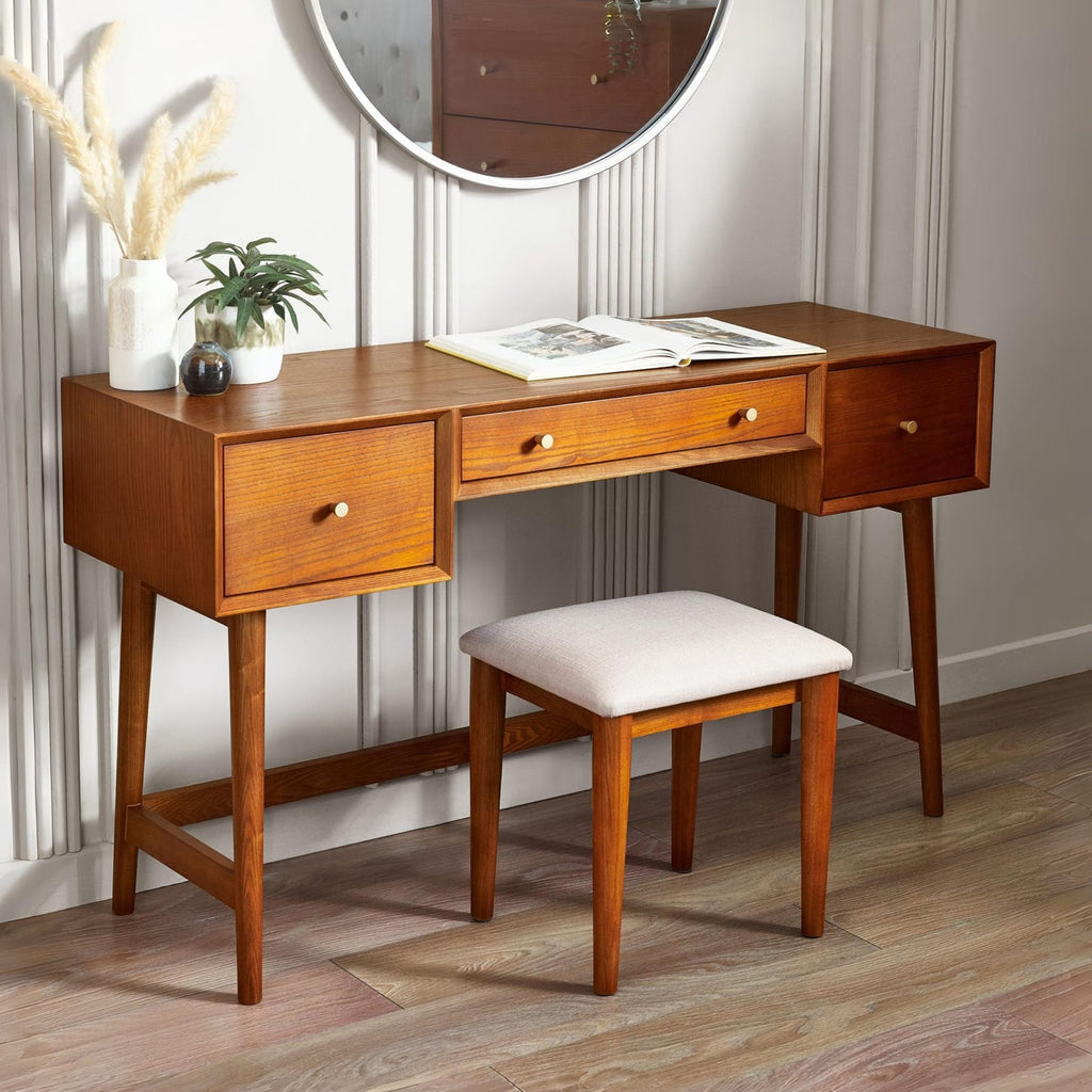 Lowry wooden dressing table and cushioned stool set styled in a modern bedroom with decorative mirror and vase.