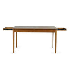 Front view studio shot of the Lowry dining table with the butterfly extension mechanism fully opened