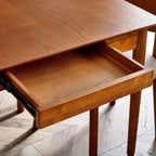 Close-up shot of the integrated side drawer pulled open on the Lowry cherry ash veneer dining table