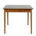 Side profile view showing the slim end apron and splayed tapered legs of the Lowry dining table