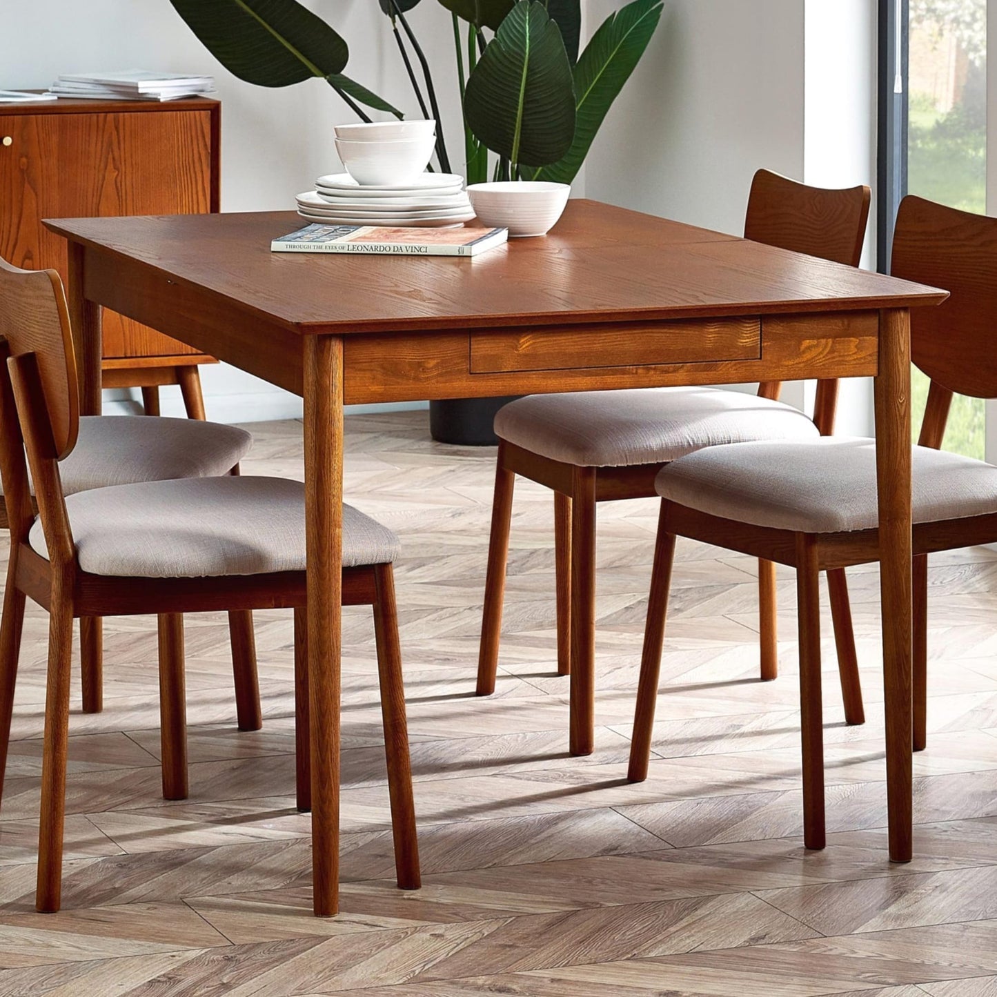 Lowry 2 drawer extending dining table in exquisite cherry ash veneer styled with chairs in a dining room