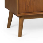 Close-up view of the splayed tapered wooden leg frame and corner joint on the Lowry media unit
