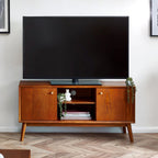 Lowry TV media unit in exquisite cherry ash veneer styled with a flat screen television in a living room