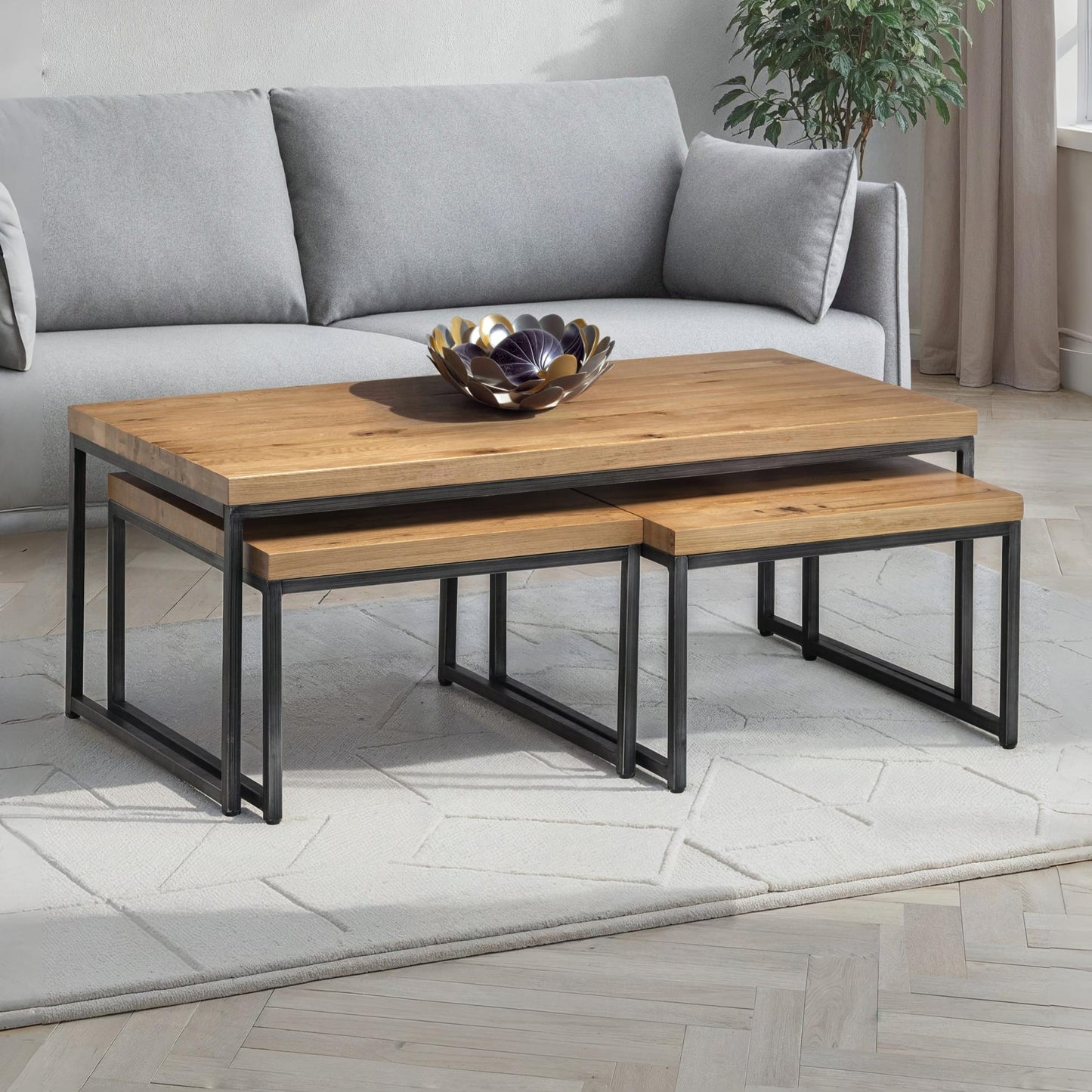 Brooklyn oak nesting coffee table set styled in a modern living room beside a grey sofa