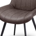 Close-up shot highlighting the dark coffee faux leather texture and channel-stitched seat detailing on the Malmo chair