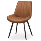 Front view showing the ribbed seat cushion and splayed black metal legs of the Malmo tan faux leather dining chair
