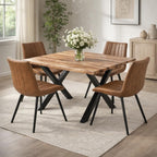 Malmo tan faux leather swivel dining chairs arranged around a wooden industrial dining table with black X-frame metal legs