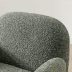 Close-up shot of the soft textured olive green fabric upholstery on the Micky swivel chair   