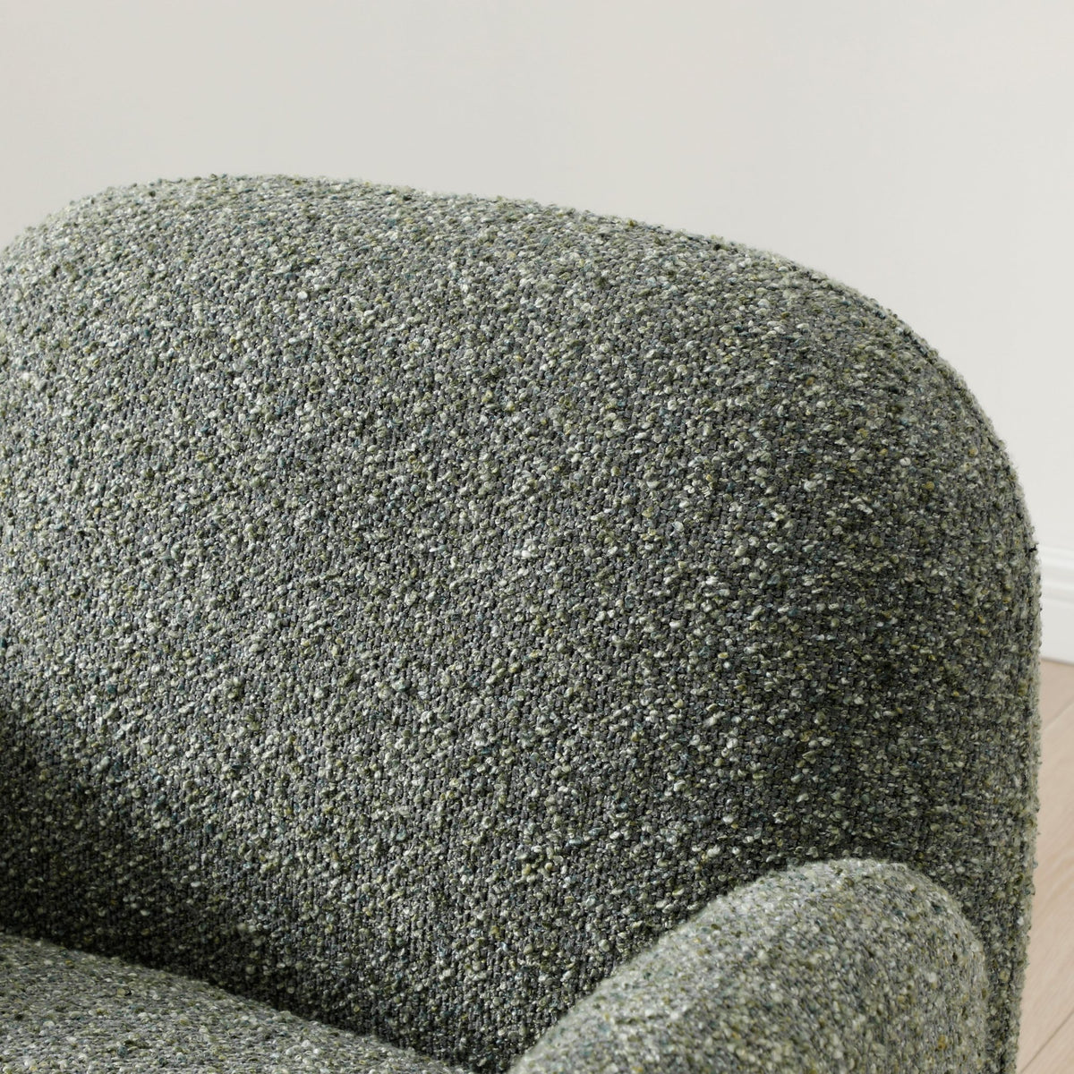 Close-up shot of the soft textured olive green fabric upholstery on the Micky swivel chair   