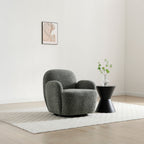 Micky swivel chair in olive green textured fabric placed in a bright, modern lounge setting   