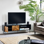 Black and wood chevron TV stand supporting a flat-screen television in a modern living room setup.