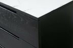 Close-up of the detailed marbled top surface against the deep black oak frame of orchid 3-drawer chest