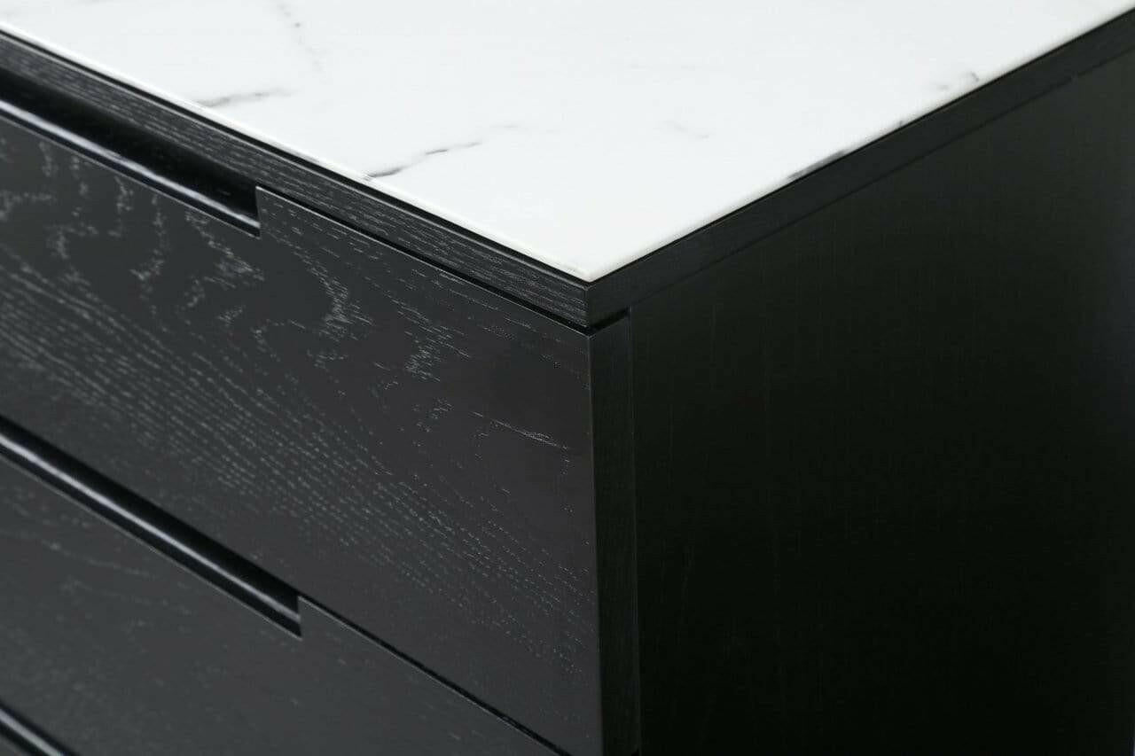 Close-up of the detailed marbled top surface against the deep black oak frame of orchid 3-drawer chest