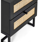 Close-up view of woven rattan cane panels and black metal frame on black oak bedside table