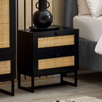 Padstow black oak 2 drawer rattan bedside table styled with vase in a bedroom setting