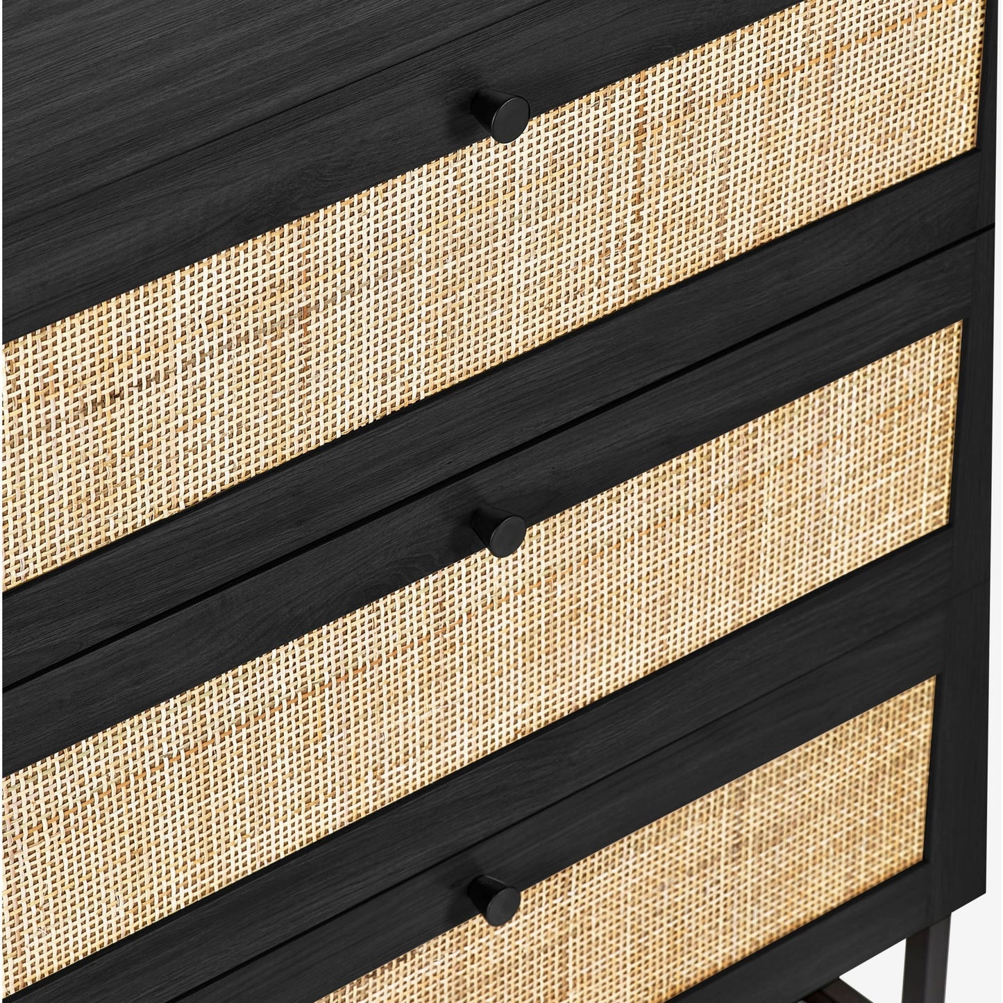 Close-up shot of the woven cane rattan detailing on the black oak 3 drawer chest