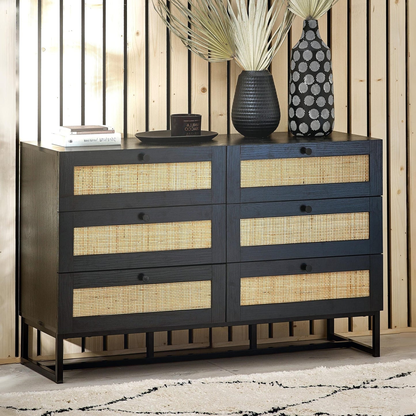 Padstow black oak 6 drawer wide rattan chest styled in a contemporary living room