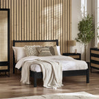 Padstow black oak wood bed frame with cane headboard in a styled bedroom