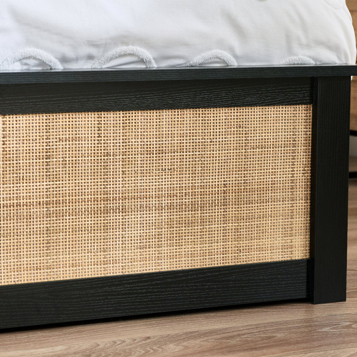 Detailed shot of the woven cane inlay on the black oak footboard
