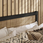 Close-up of the woven rattan cane headboard within the black oak frame