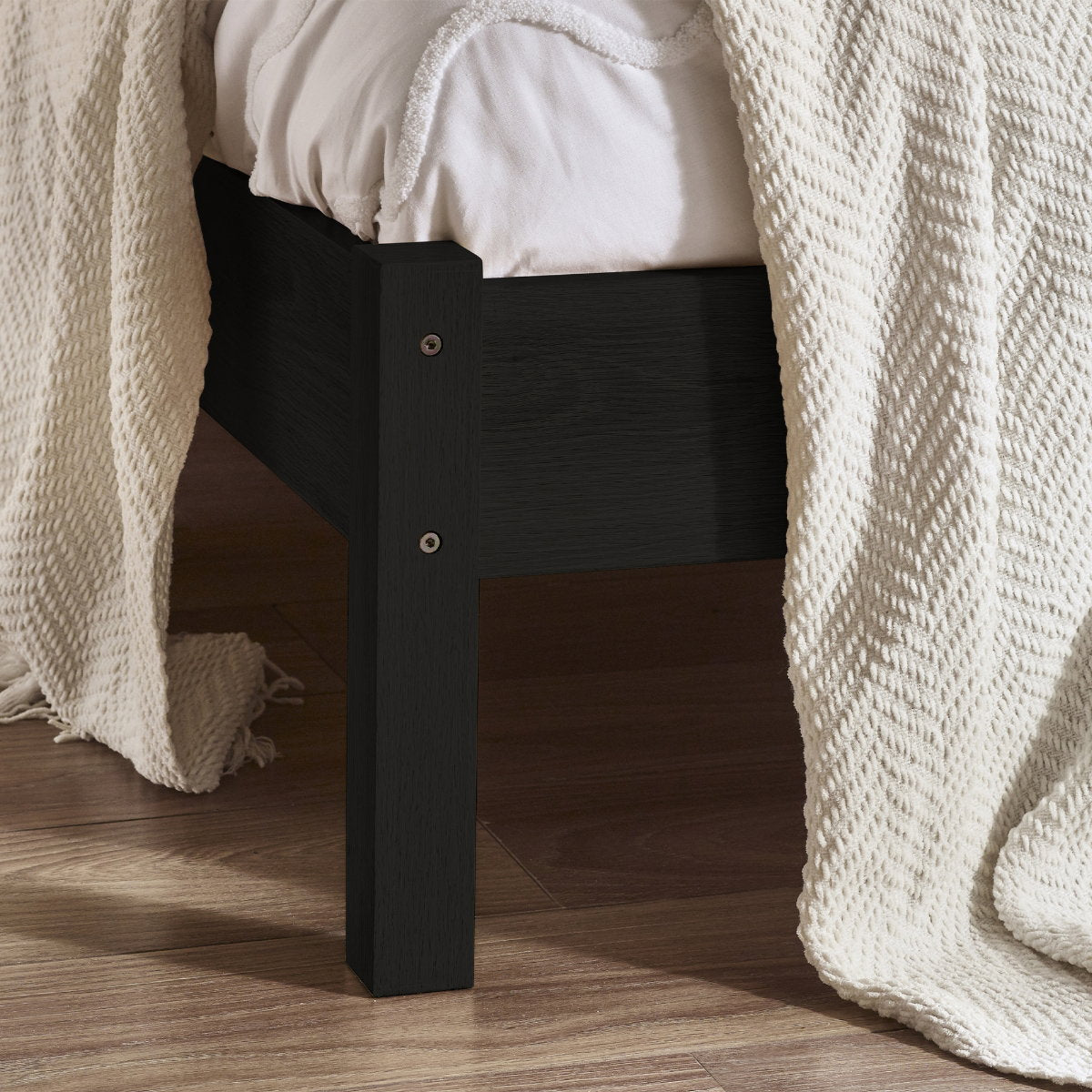 Detailed view of the corner leg and black oak wood finish on the Padstow bed