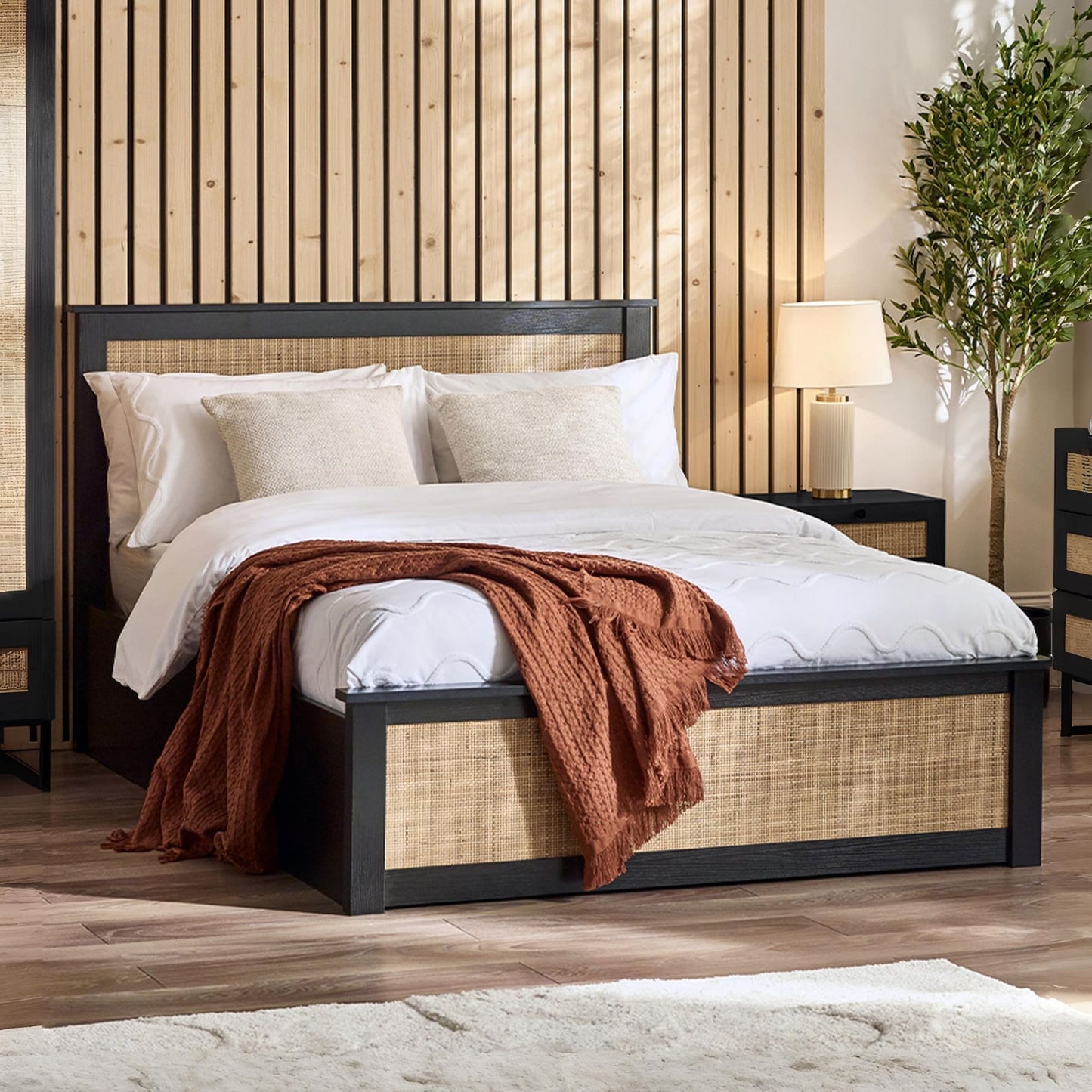 Padstow black oak ottoman bed with lift-up storage styled in a bedroom