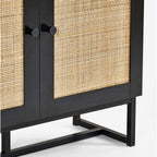 Close-up shot of the natural cane door weave and black metal handles on the black oak bookcase