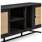 Close-up shot of natural cane door panels and black metal base on the black oak TV unit