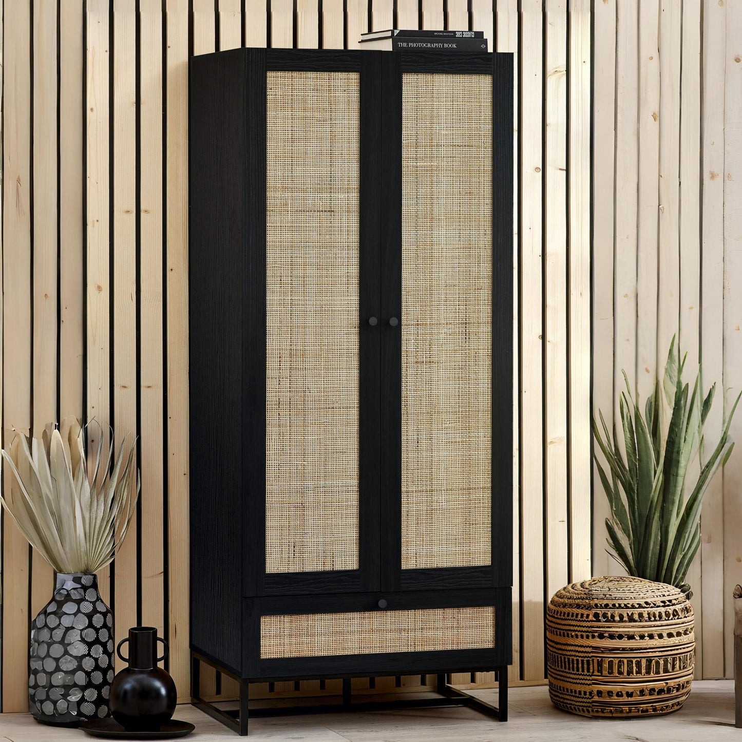 Padstow black oak 2 door rattan wardrobe styled in a modern bedroom setting with neutral accents