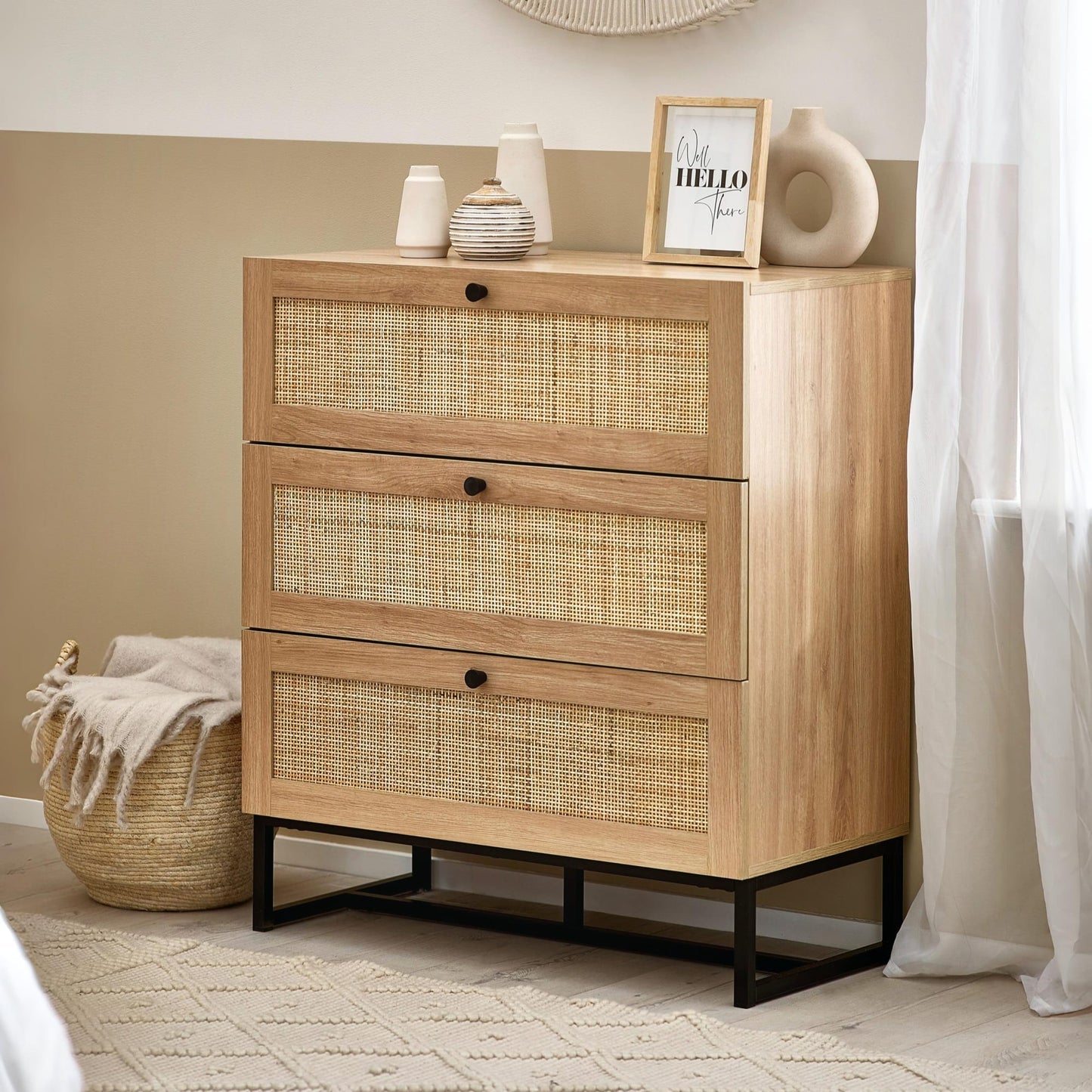 Padstow natural oak 3 drawer chest with rattan fronts styled in a modern bedroom