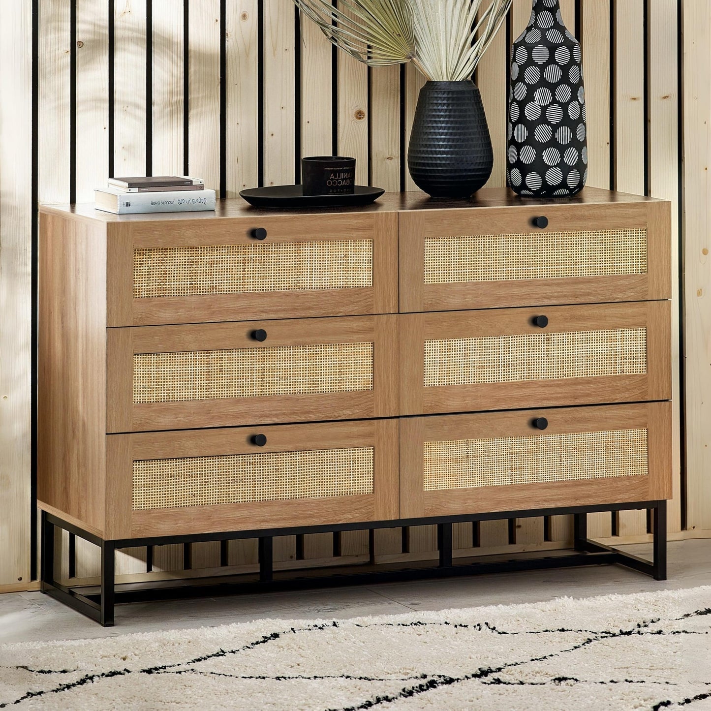 Padstow natural oak 6 drawer wide chest with rattan drawer fronts styled in a modern room setting