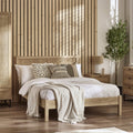 Padstow natural oak wood bed frame with cane headboard in a styled bedroom