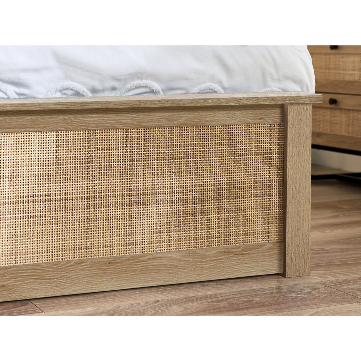 Detailed shot of the woven cane inlay on the natural oak footboard