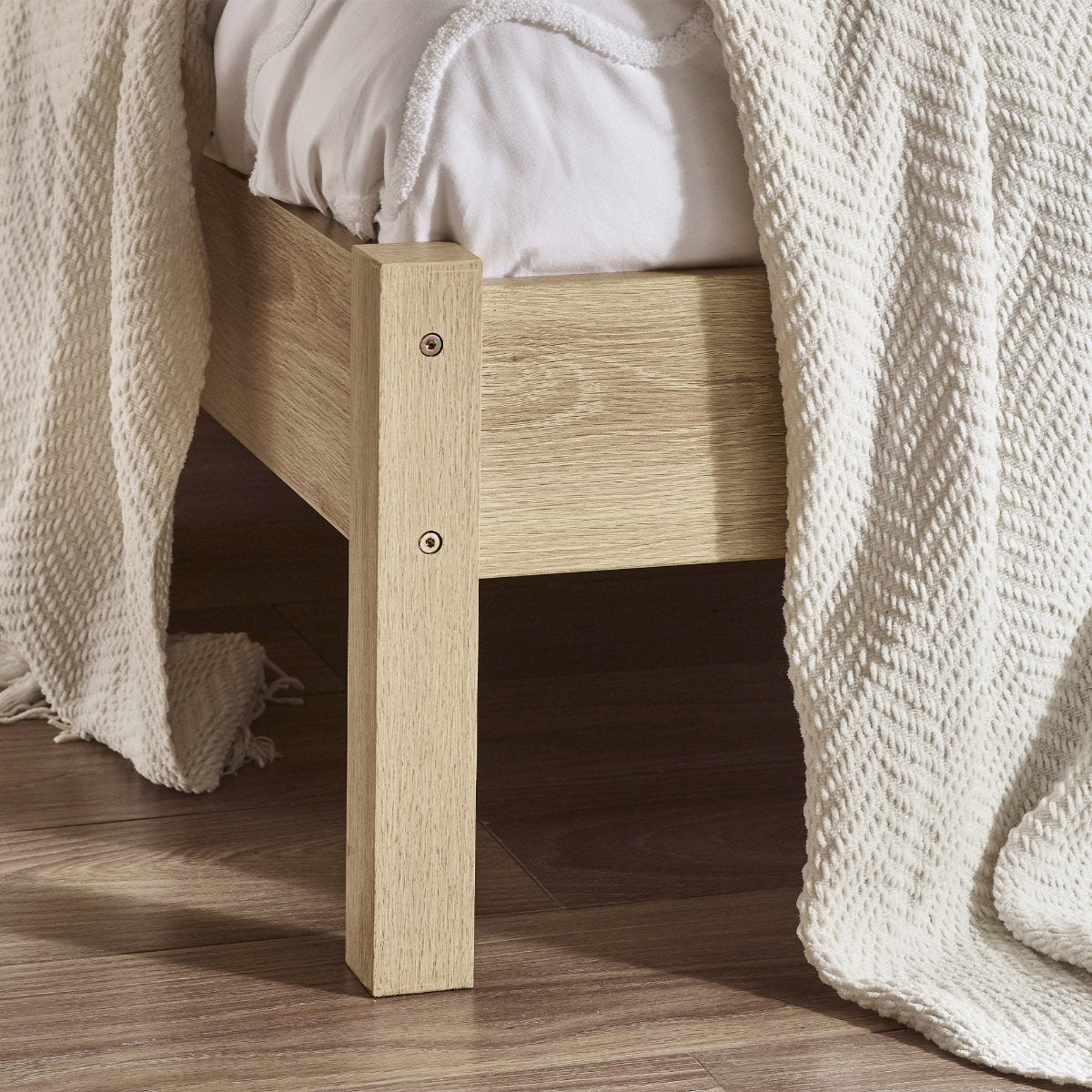 Detailed view of the corner leg and oak wood finish on the Padstow bed frame