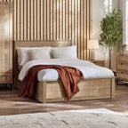 Padstow natural oak ottoman bed with lift-up storage styled in a bedroom